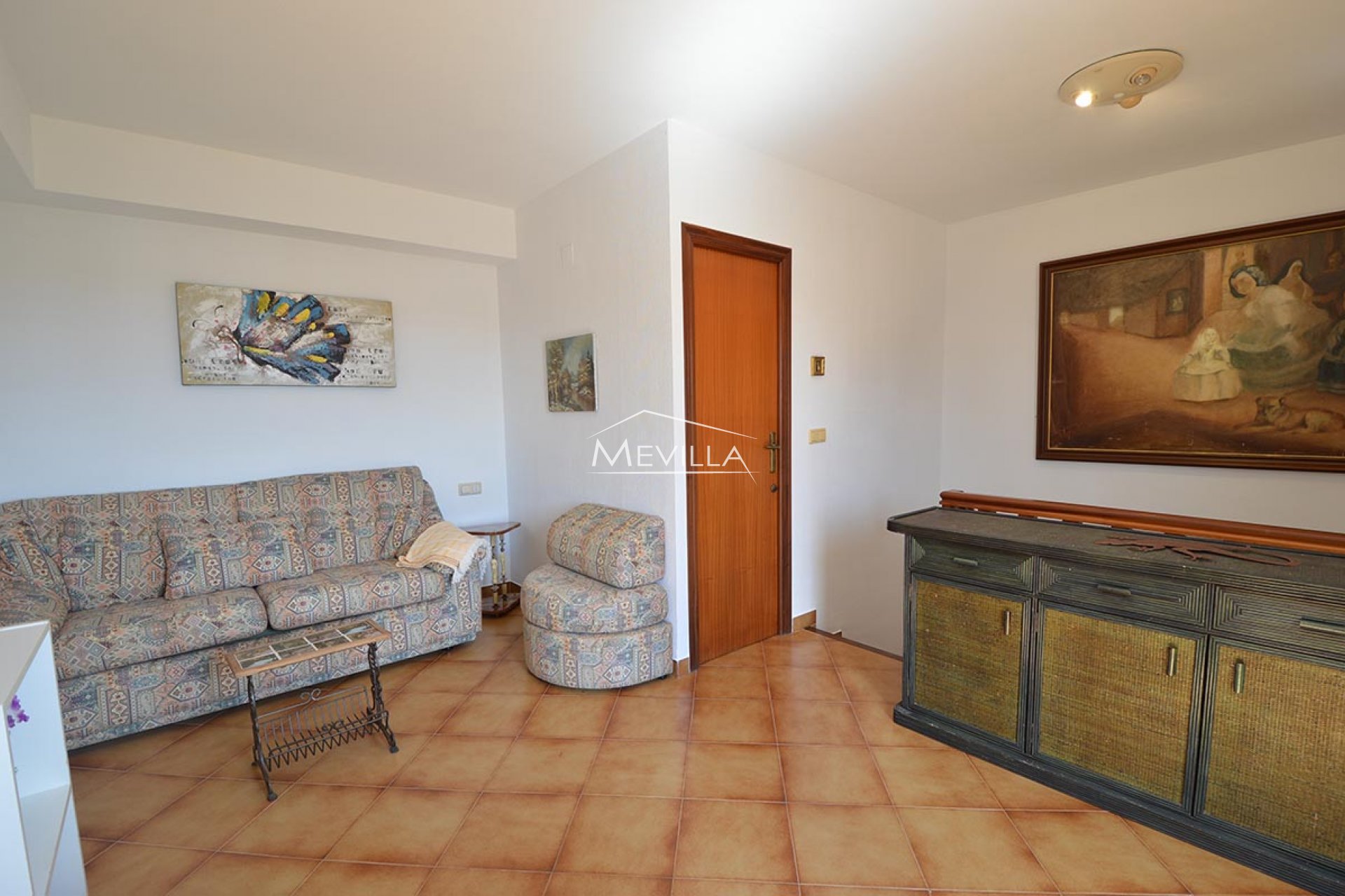 The living room and a door of bathroom on the second floor